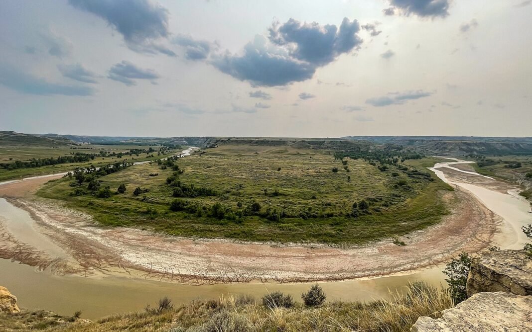 Moving to North Dakota in 2026: Complete Relocation Guide Theodore Roosevelt National Park North Dakota badlands landscape with rolling hills and prairie, 2024