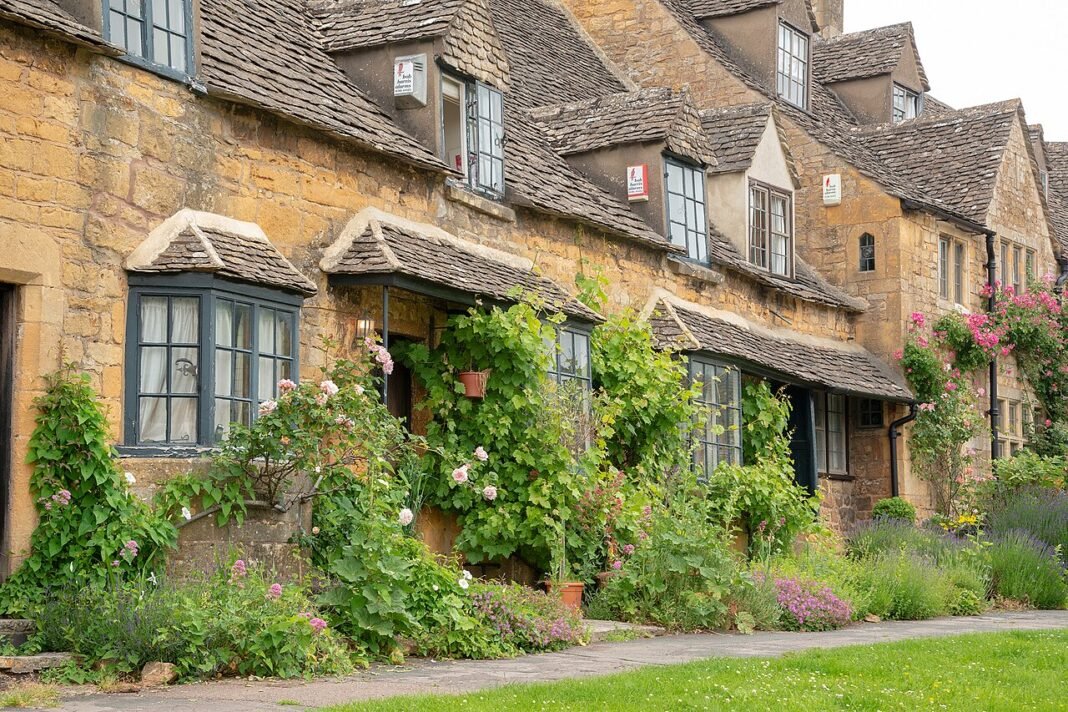 The Cotswolds: A Complete Village-by-Village Guide Restored Cotswold stone row houses in Broadway village Worcestershire England June 2018