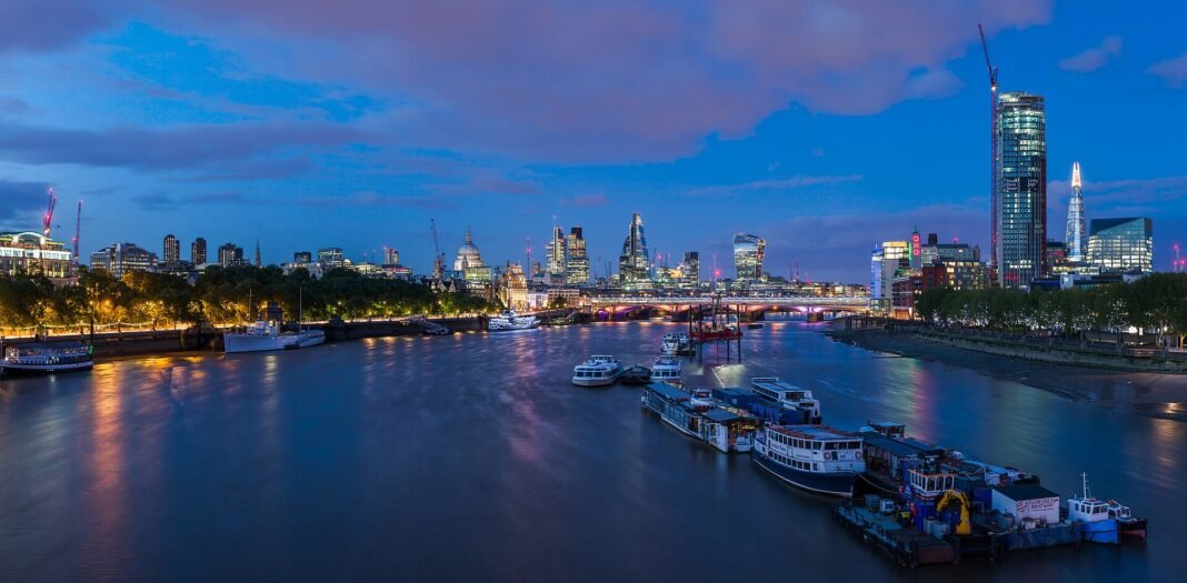 Best Cities in England 2026: London, Manchester, Bristol, York, and Where to Live London skyline at twilight over the River Thames with St Paul Cathedral the Shard and the City of London England UK