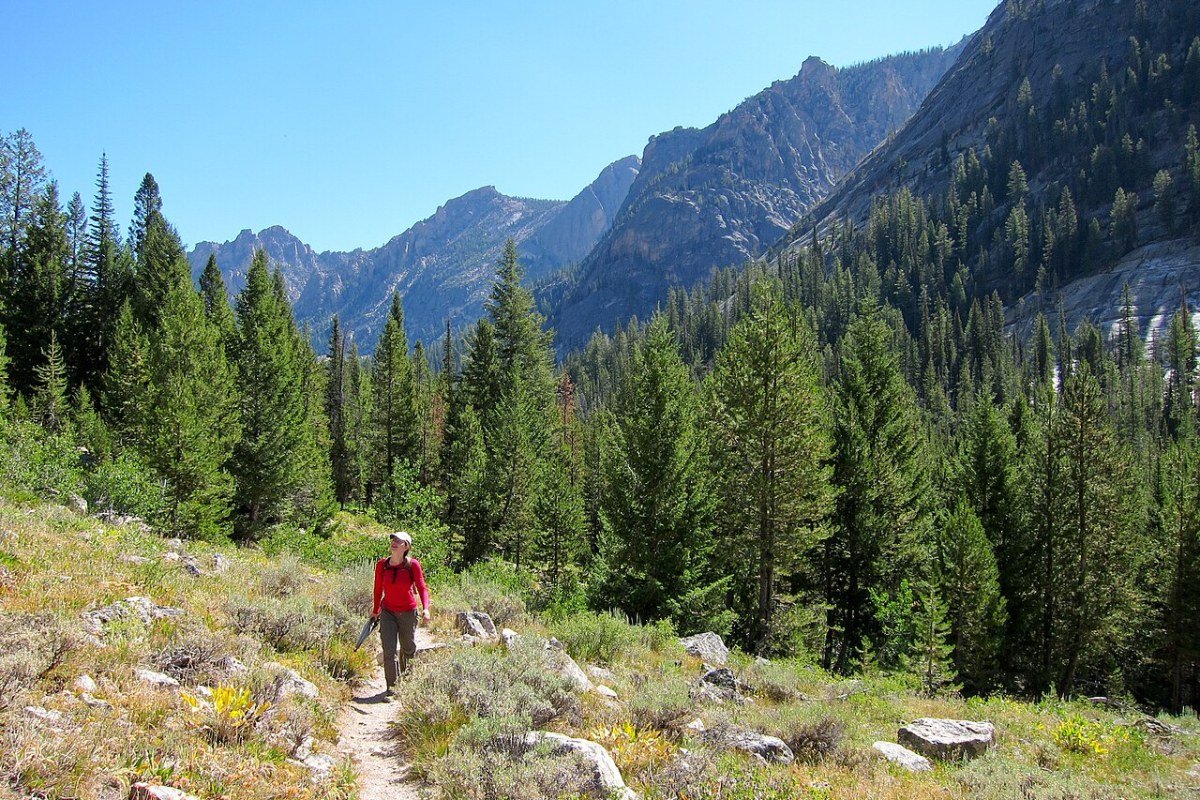 Idaho Outdoor Activities 2026: Adventures in America’s Most Wild State Hiker on alpine lake trail in Sawtooth Wilderness Idaho Rocky Mountains