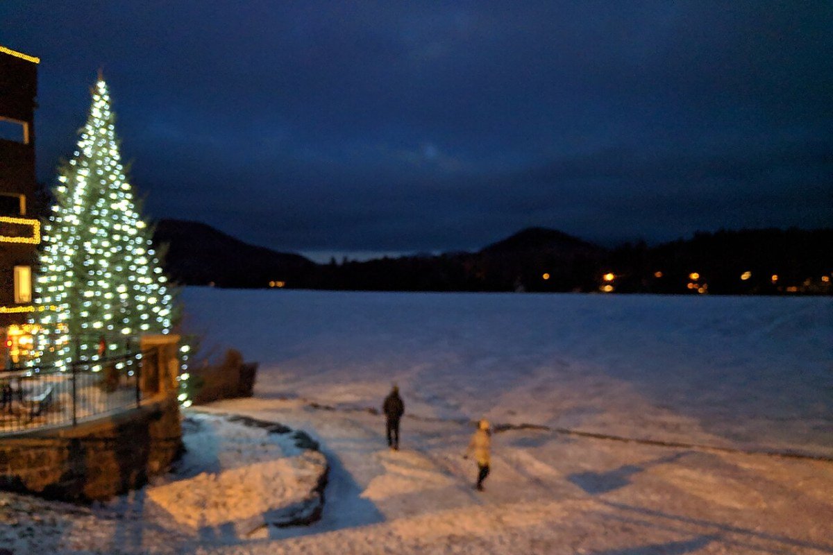 Moving to New York in 2026: Complete Relocation Guide Lake Placid New York Adirondacks village reflection mirror lake at night