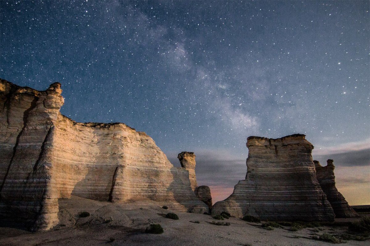 Kansas Outdoor Activities 2026: Prairie, Reservoirs, and Big-Sky Adventure Milky Way galaxy over Monument Rocks chalk formations Kansas dark sky