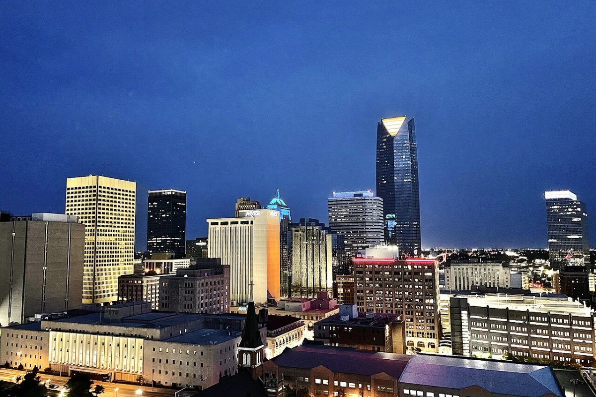 Cost of Living in Oklahoma 2026: Deep South Plains Affordability Oklahoma City skyline reflection at night downtown oil country
