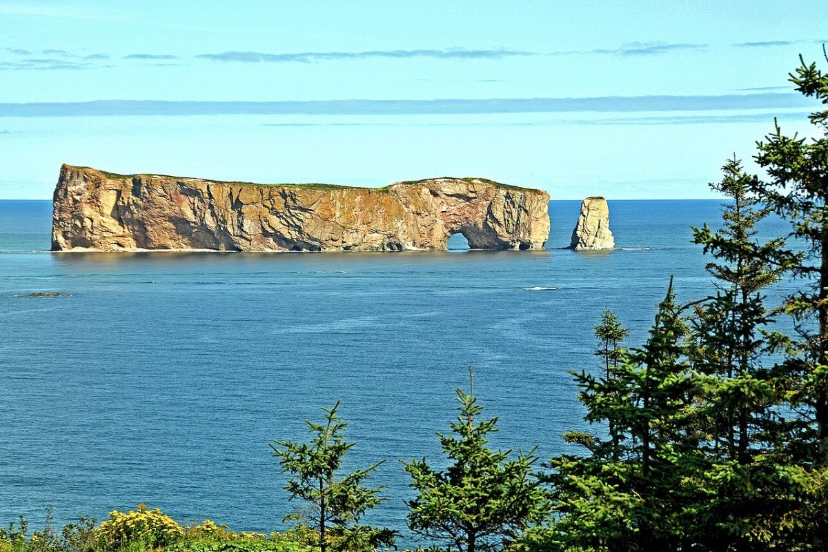 Outdoor Activities in Quebec 2026: Ski the Laurentians, Paddle the Gaspésie, and Kayak the Fjord Percé Rock natural arch along the Gaspésie coast Quebec Canada