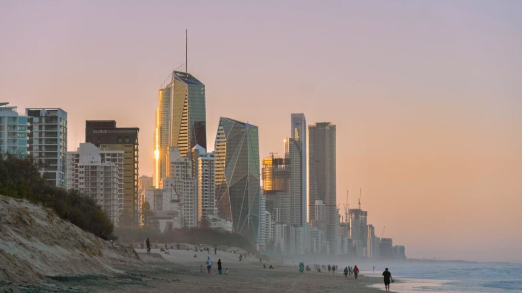 Gold Coast and Queensland Beaches: Sun, Surf, and Theme Parks Surfers Paradise skyline and beach at sunset Gold Coast Queensland Australia
