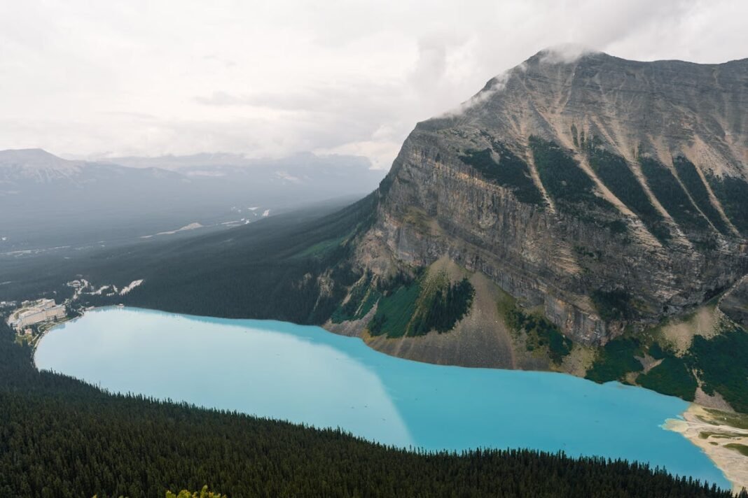 Alberta Travel Guide 2026: Banff, Jasper, and the Canadian Rockies Aerial view of Lake Louise turquoise waters surrounded by mountains in Banff National Park Alberta