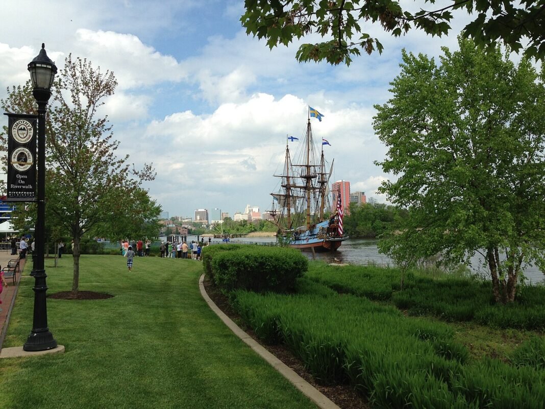 Moving to Delaware in 2026: The Complete Relocation Guide Wilmington Riverfront park along the Christina River with the tall ship Kalmar Nyckel and downtown skyline behind, Delaware