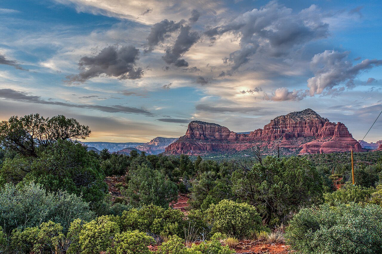 Sedona red rock landscape viewed from Airport Mesa Arizona with dramatic cloudy sky over Bell Rock and Courthouse Butte