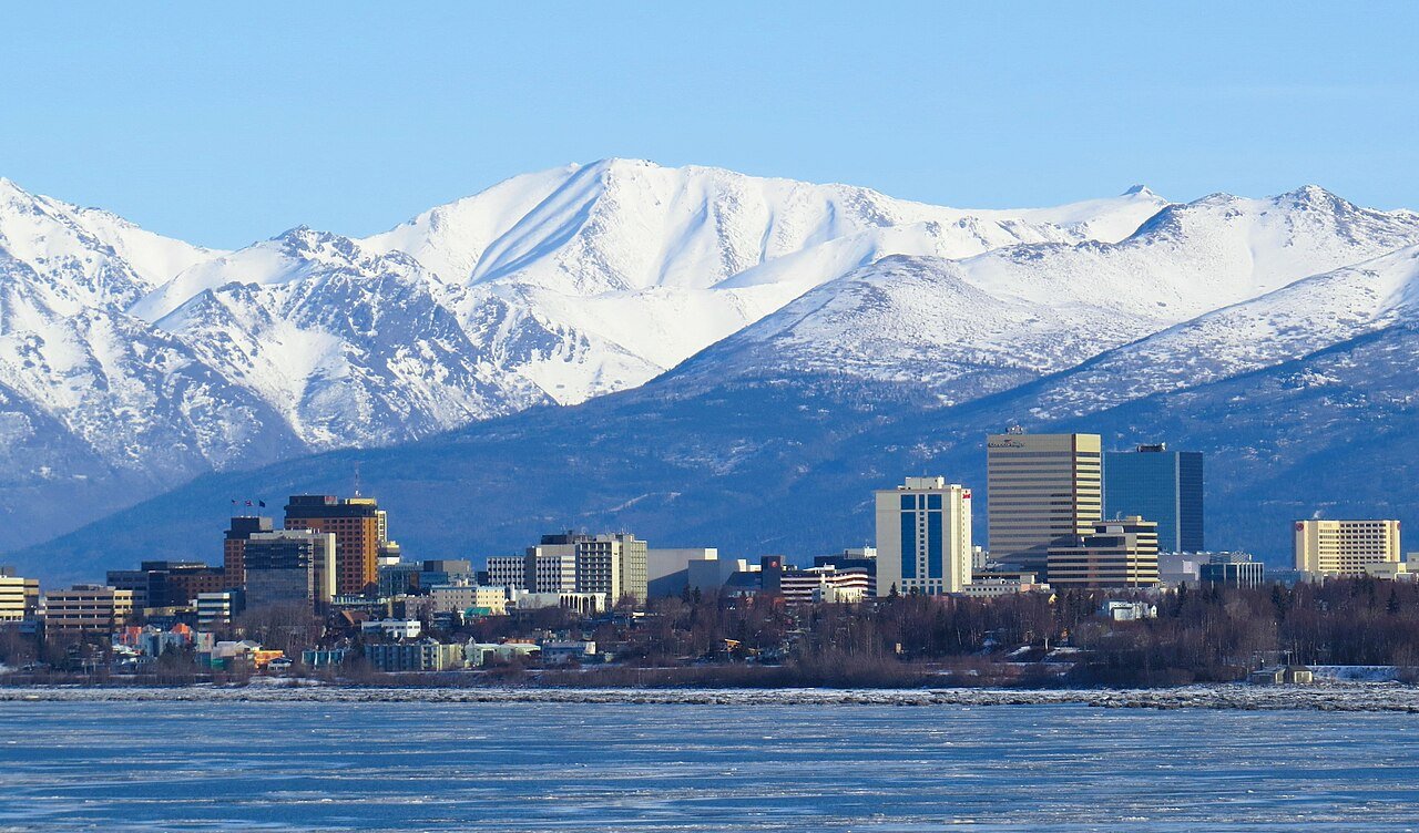 Anchorage Alaska skyline with snow-capped Chugach Mountains backdrop across Cook Inlet in winter