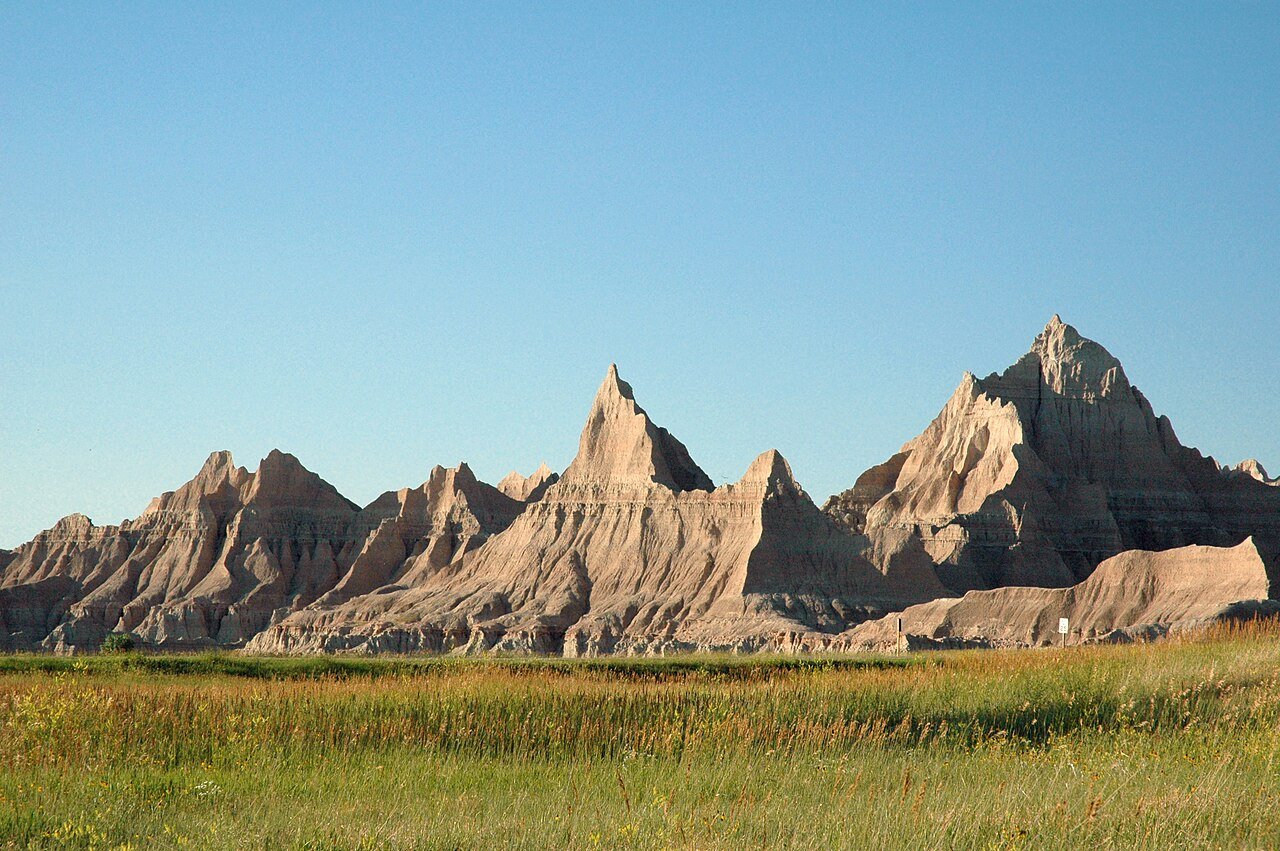 Badlands National Park South Dakota pinnacles buttes formations sunset golden light prairie landscape