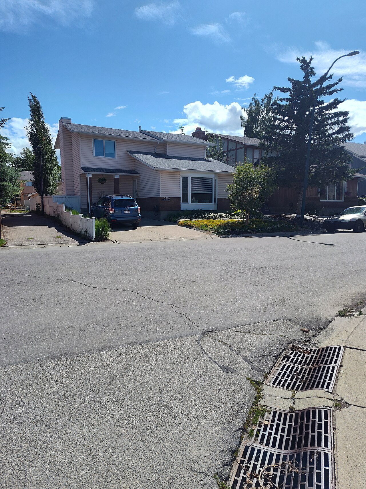 Calgary Alberta Canada Woodbine neighbourhood suburban residential homes Rocky Mountains backdrop