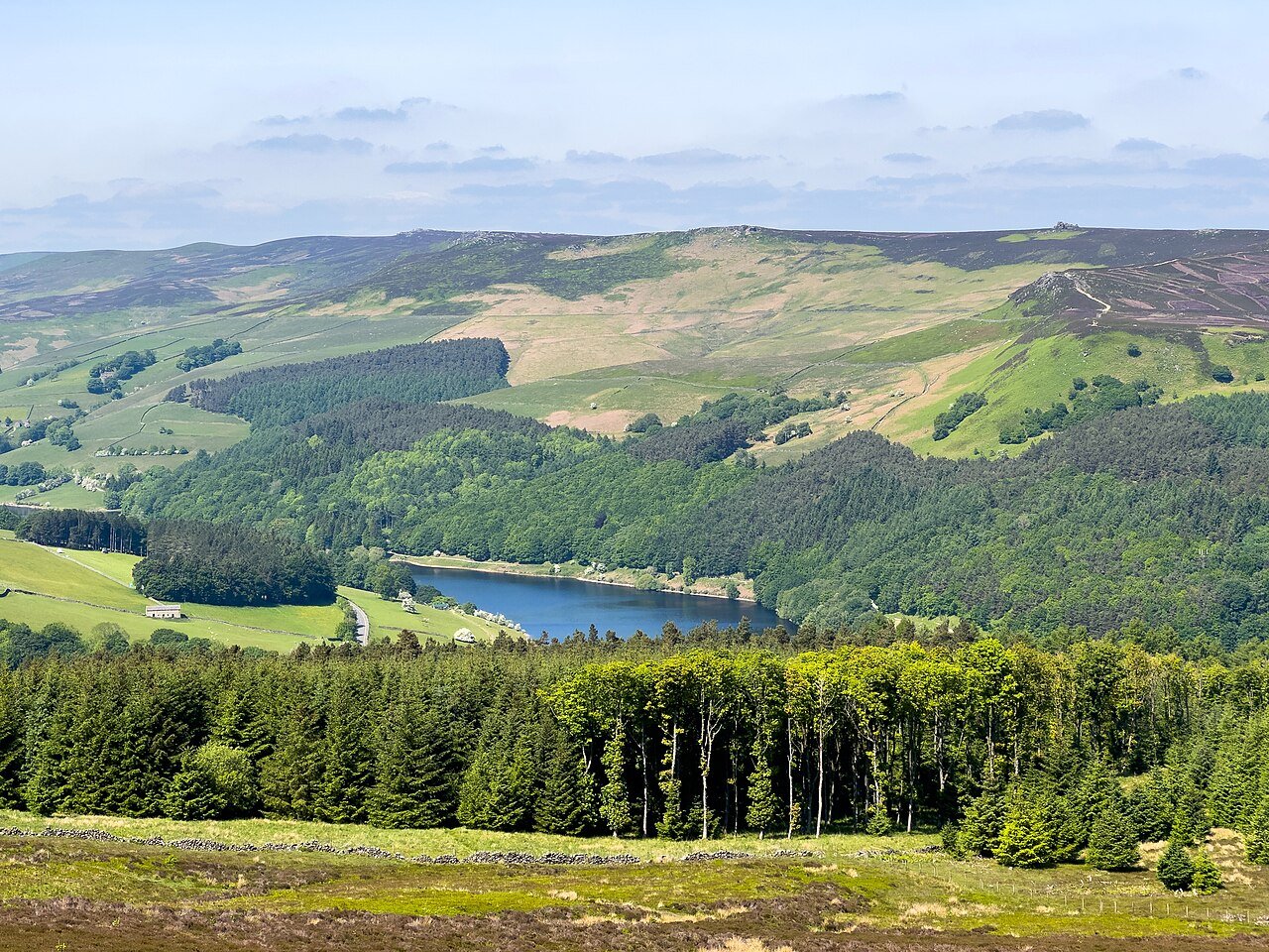Peak District reservoir and moorland panorama — England's first national park spread across Derbyshire and the edges of Greater Manchester