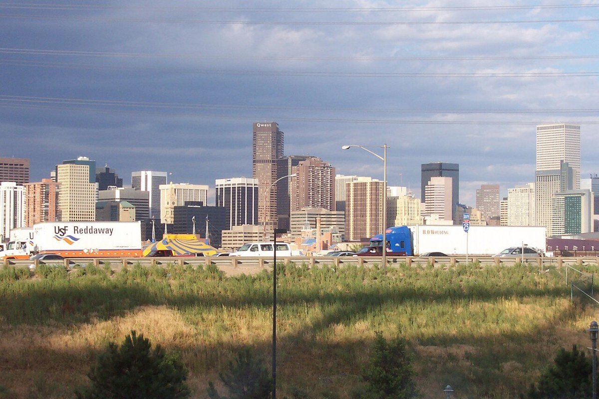 Cost of Living in Colorado 2026: The Mile High Price Tag Explained Downtown Denver skyline Colorado at dusk with Rocky Mountains backdrop
