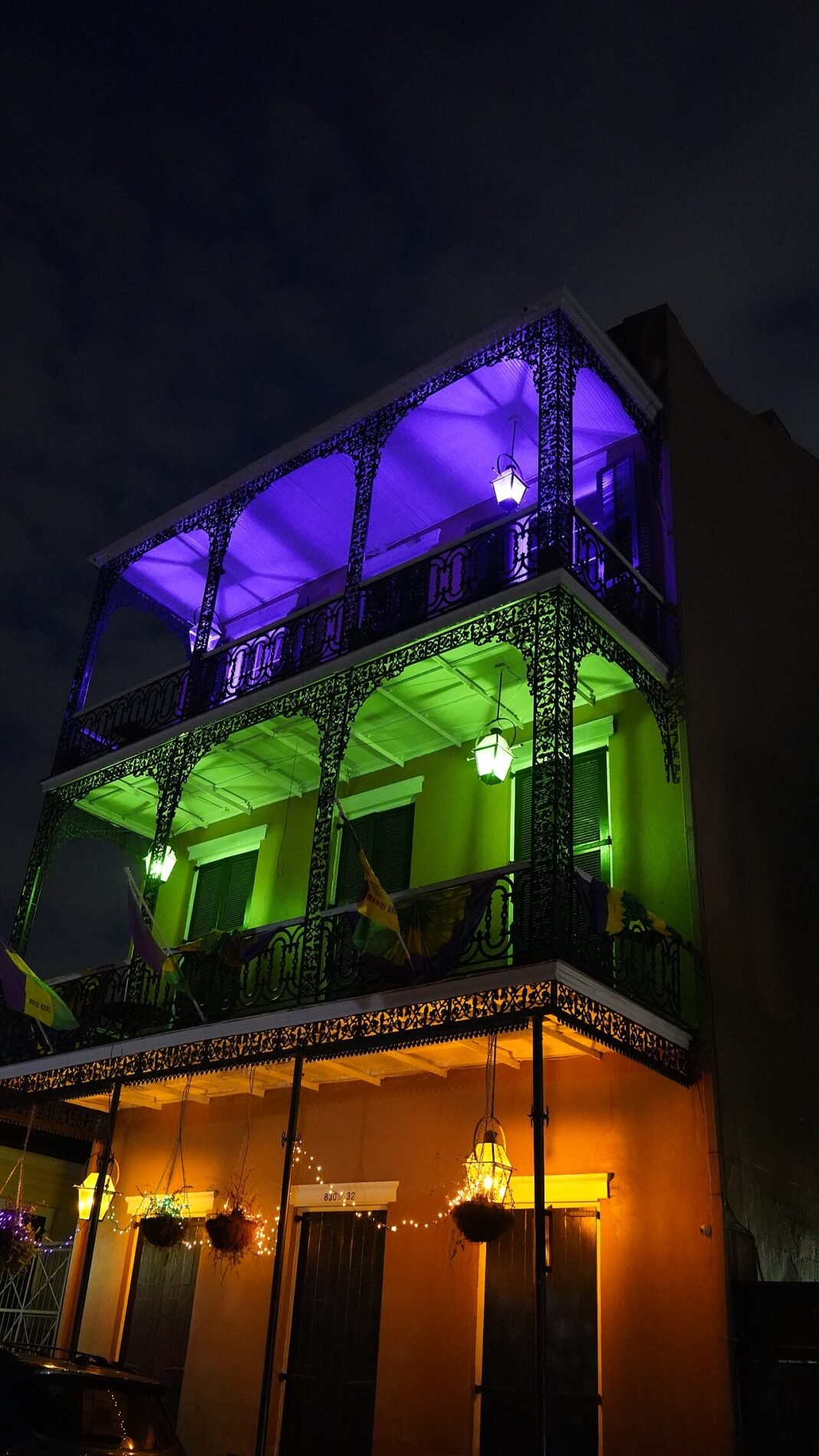 New Orleans Travel Guide: Food, Music, and Southern Soul Mardi Gras illuminated balcony New Orleans Louisiana USA French Quarter festival celebration travel guide