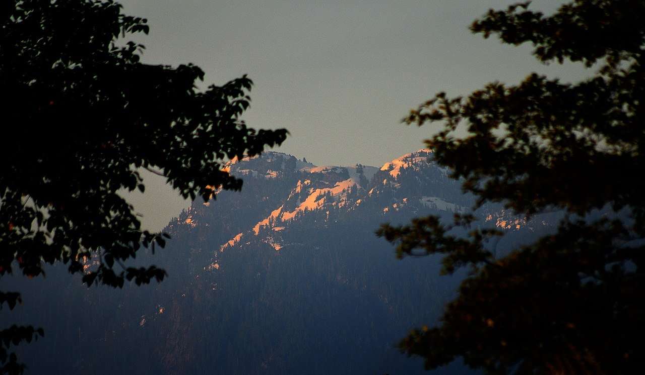North Vancouver and the North Shore mountains across Burrard Inlet — the dramatic backdrop of snowcapped peaks that makes Vancouver one of the world's most spectacularly situated cities, with skiing at Grouse Mountain just 20 minutes from downtown — the dramatic mountain backdrop that defines the city