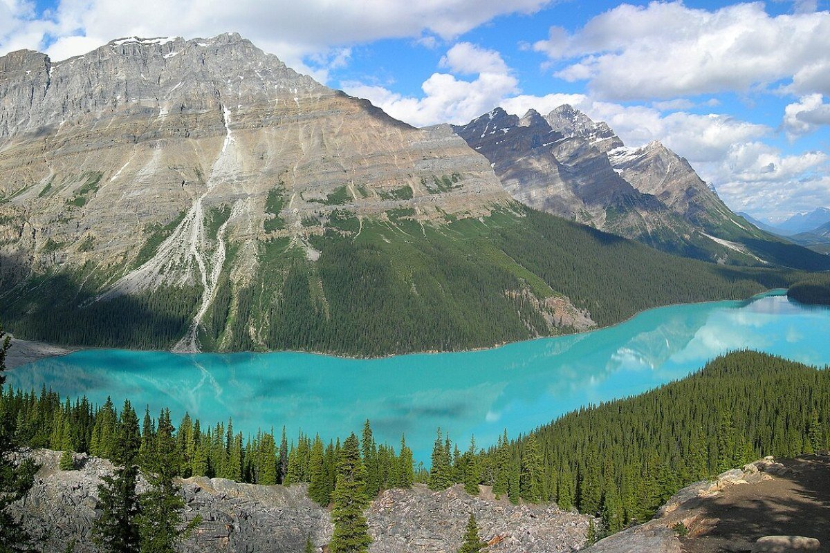 Budget Travel in Canada: Seeing the Great White North Without Going Broke Peyto Lake vivid turquoise glacial water Banff National Park Alberta Canadian Rockies