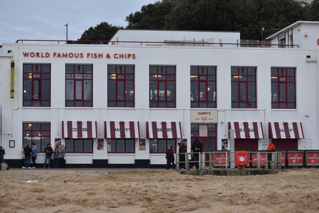 The Best British Food Experiences You Can’t Miss Classic British fish and chips wrapped in paper at the seaside England