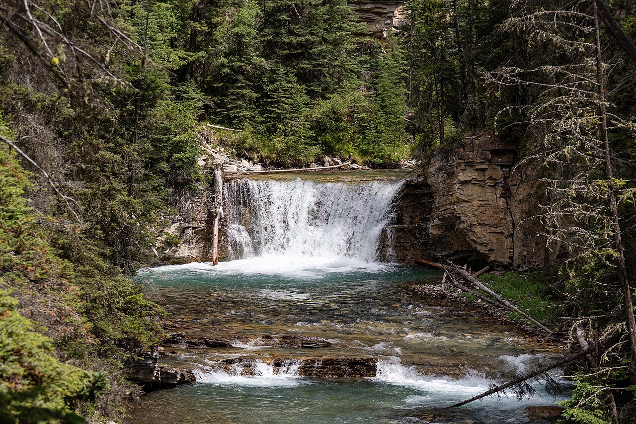 Waterfall in Johnston Canyon Banff National Park — one of the most popular hikes in the Canadian Rockies, with suspended walkways through the canyon