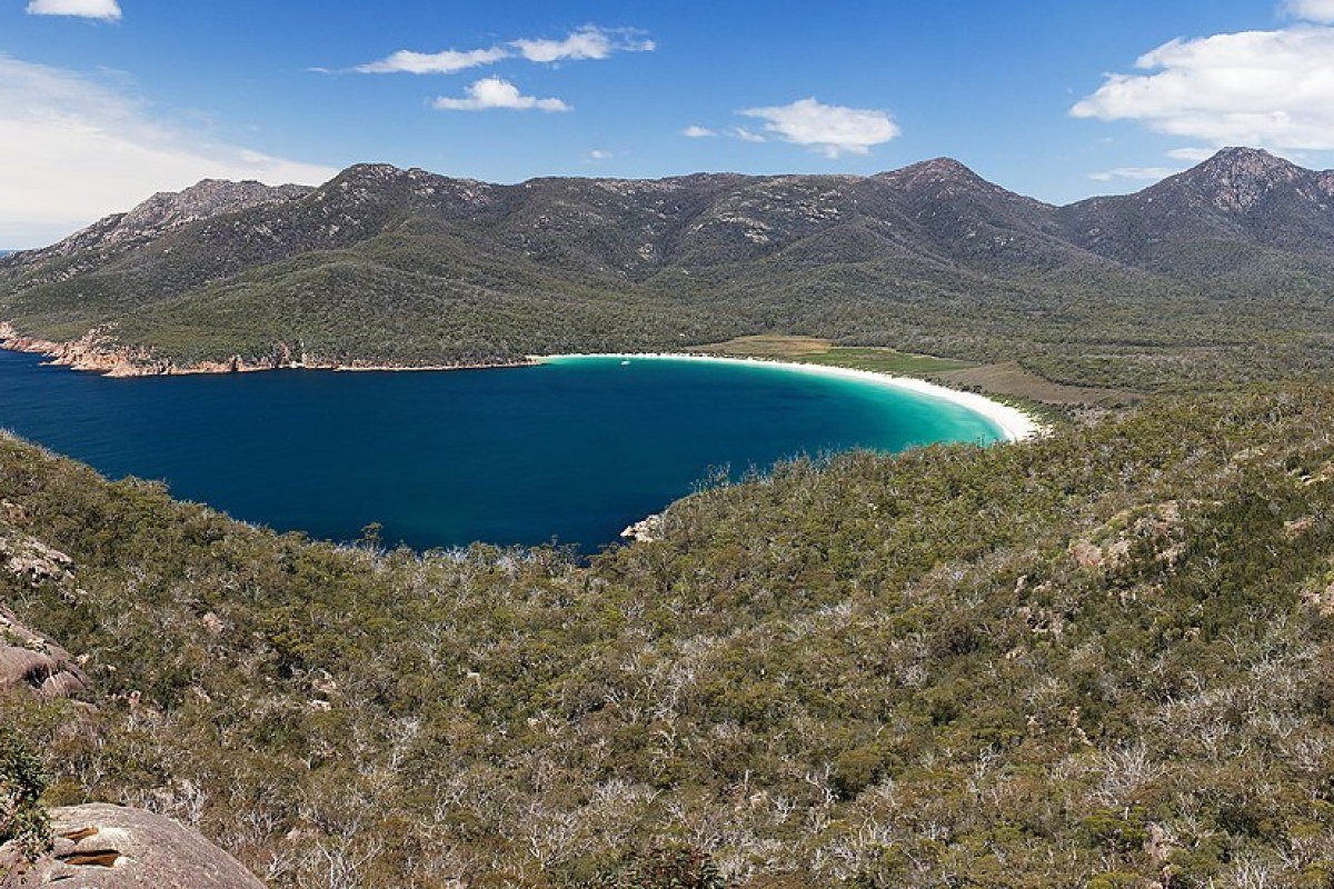 Tasmania Travel Guide: Wilderness, MONA, and the Best Food in Australia Wineglass Bay from the lookout Freycinet National Park Tasmania Australia turquoise water and white sand