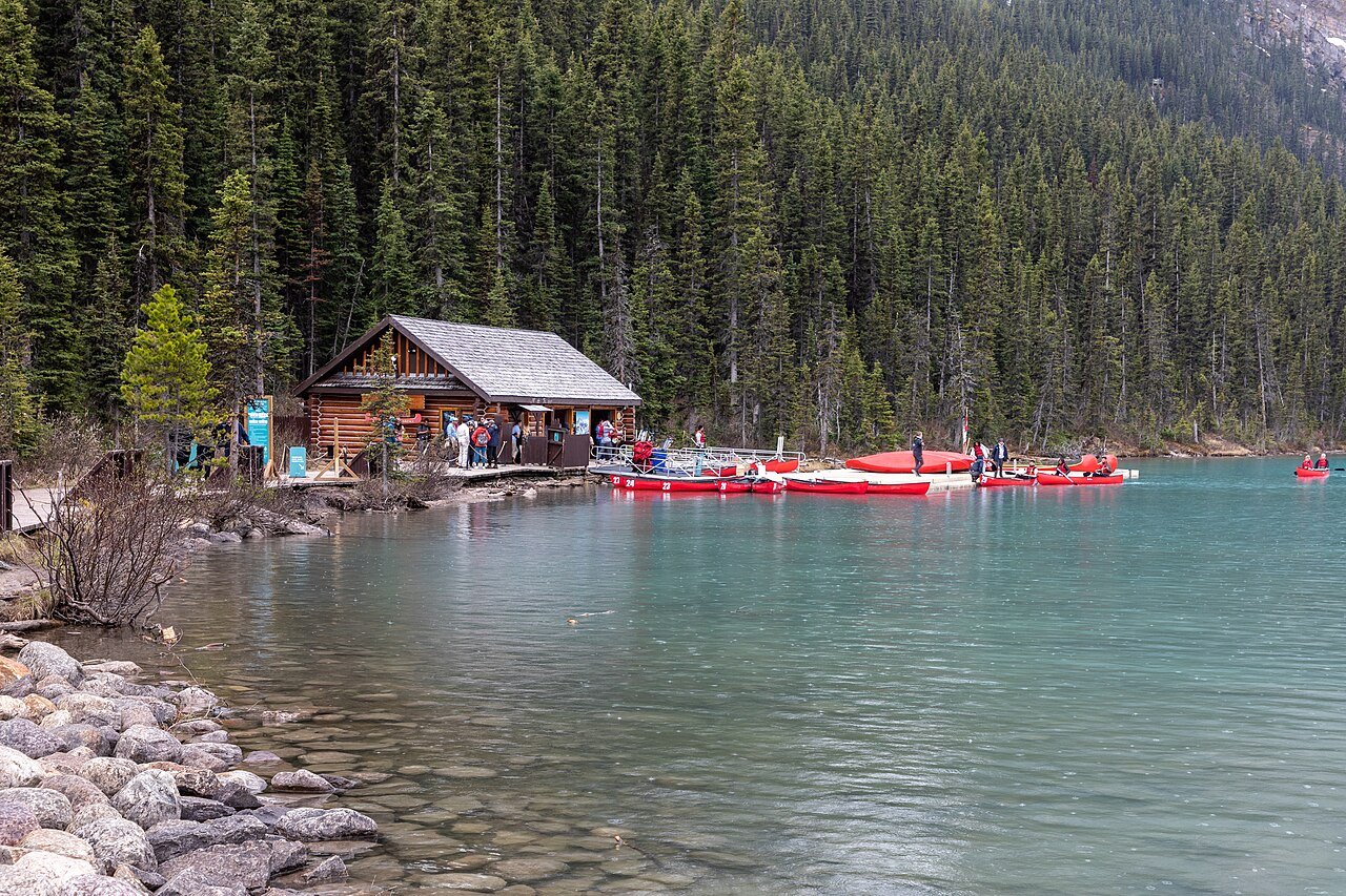 Lake Louise boathouse and red canoes on turquoise glacial water in Banff National Park Alberta Canada
