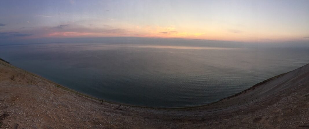 Cost of Living in Michigan 2026: Detroit’s Value and the Northern Michigan Premium Lake Michigan panorama from Sleeping Bear Dunes, Michigan