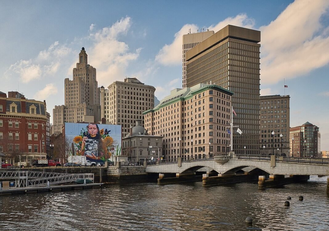 Best Places to Live in Rhode Island 2026: Providence, Newport, and the Ocean State’s Hidden Communities Downtown Providence Rhode Island skyline along the Providence River
