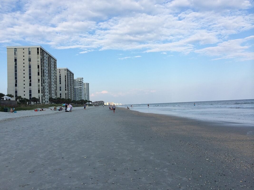 Cost of Living in South Carolina 2026: Affordable Living With Southern Charm Wide sandy beach and oceanfront high-rise condos at Myrtle Beach, South Carolina