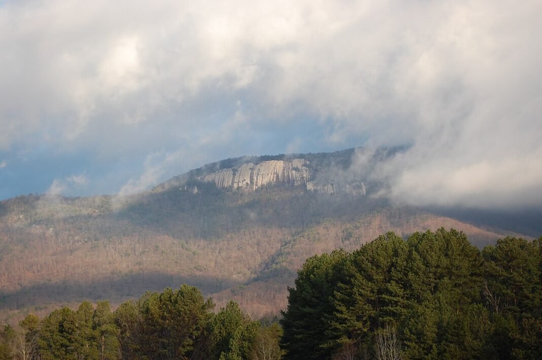 Outdoor Activities in South Carolina 2026: Waterfalls, Forests, and Coastline Table Rock Mountain 3124-foot granite dome rising above misty Pickens County forest in Table Rock State Park South Carolina Blue Ridge Escarpment Upstate