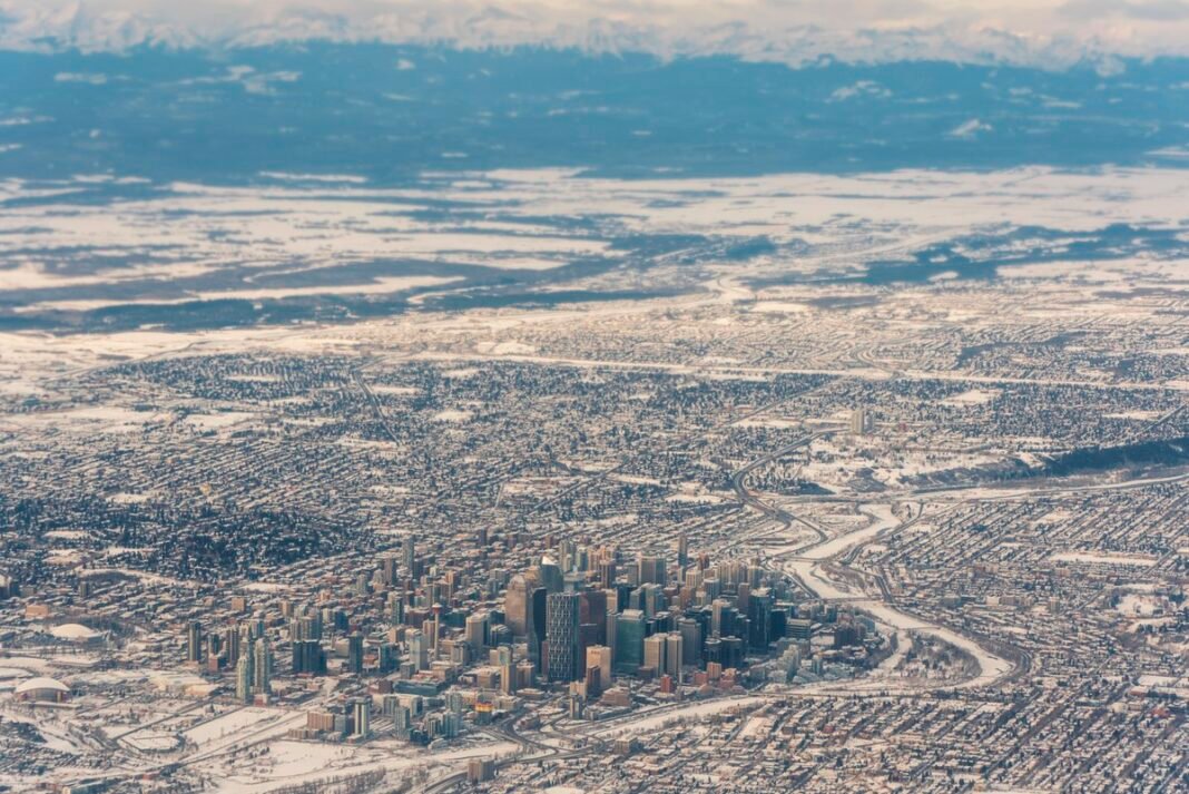 Cost of Living in Alberta 2026: Canada’s Lowest Income Tax and Calgary’s Housing Market Calgary Alberta Canada downtown skyline aerial Rocky Mountains backdrop winter snow