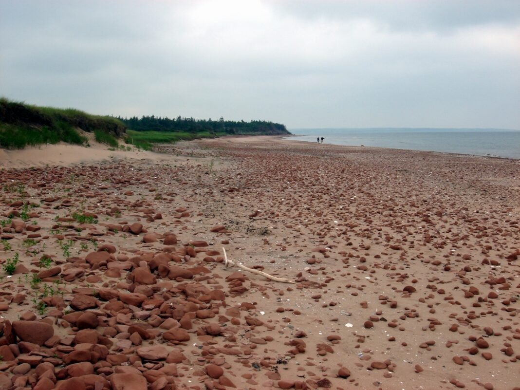 Cost of Living in Prince Edward Island 2026: The Garden Province’s Affordable Island Life Red sand beach at Prince Edward Island National Park, Canada