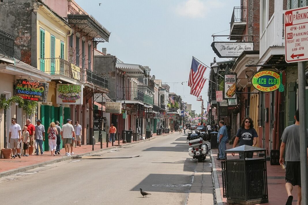 New Orleans Travel Guide: Food, Music, and Southern Soul Bourbon Street in the French Quarter of New Orleans, lined with historic iron-balcony buildings, music bars, and daiquiri shops