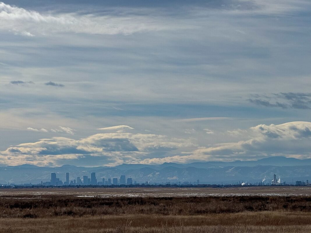 Best Places to Visit in Colorado: Mountains, Parks and Cities Denver skyline with Rocky Mountains in background, Colorado