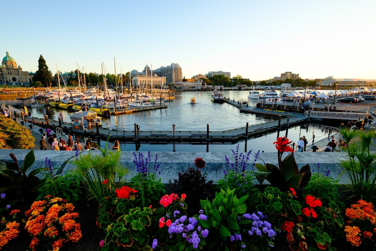 Victoria British Columbia Inner Harbour Parliament buildings flowers sailboats sunset