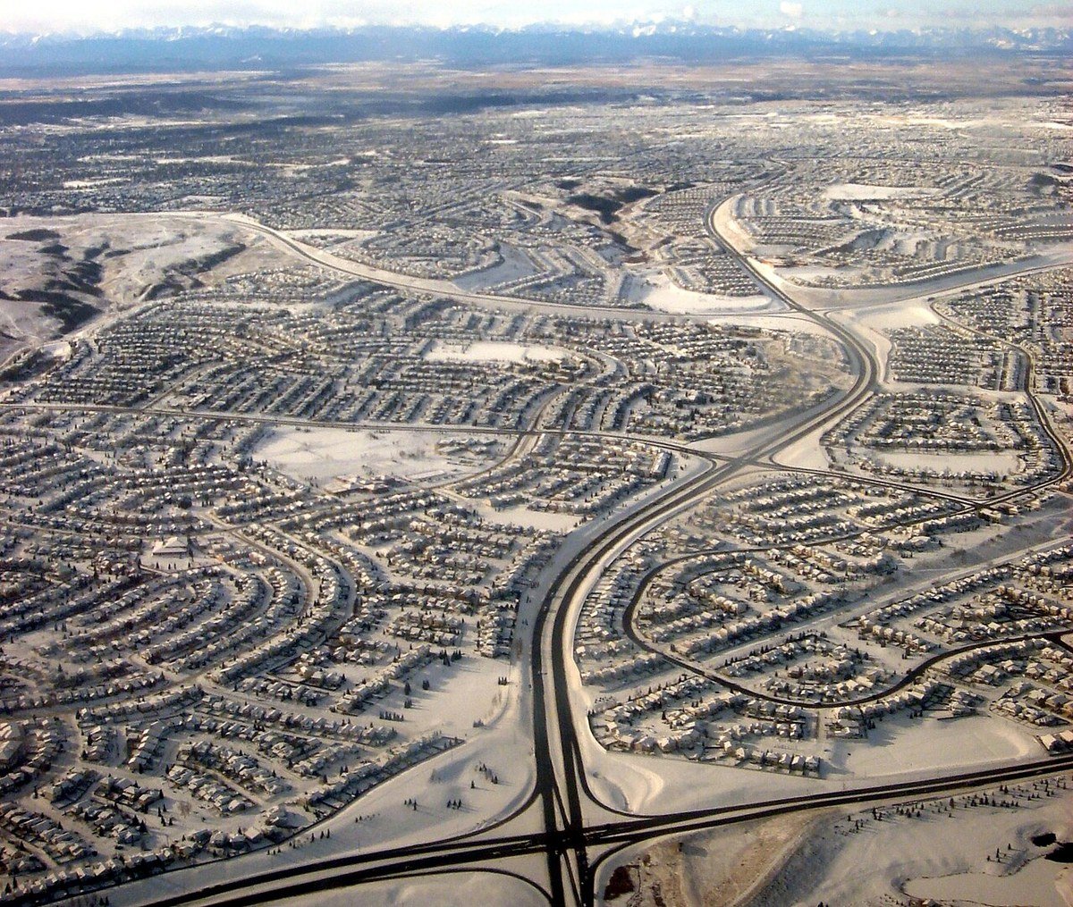 Calgary Alberta Canada Sandstone Valley northwest aerial planned community pathway streets Rocky Mountains backdrop winter