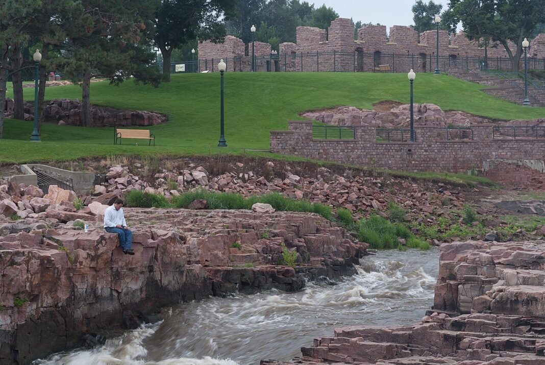 Best Places to Live in South Dakota 2026: Sioux Falls, Rapid City, and More Falls of the Big Sioux River at Falls Park in downtown Sioux Falls South Dakota with Queen Bee Mill ruins