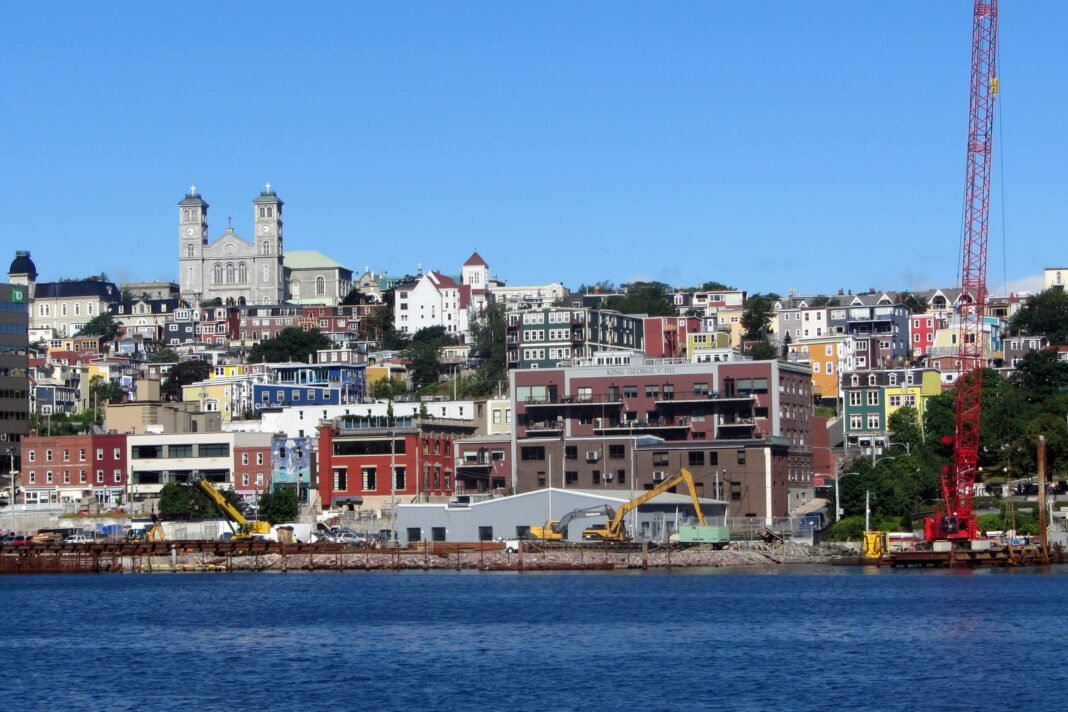 Cost of Living in Newfoundland and Labrador 2026: Atlantic Affordability and Resource Economy Downtown St. Johns Newfoundland colourful hillside houses and harbour with the Basilica towers