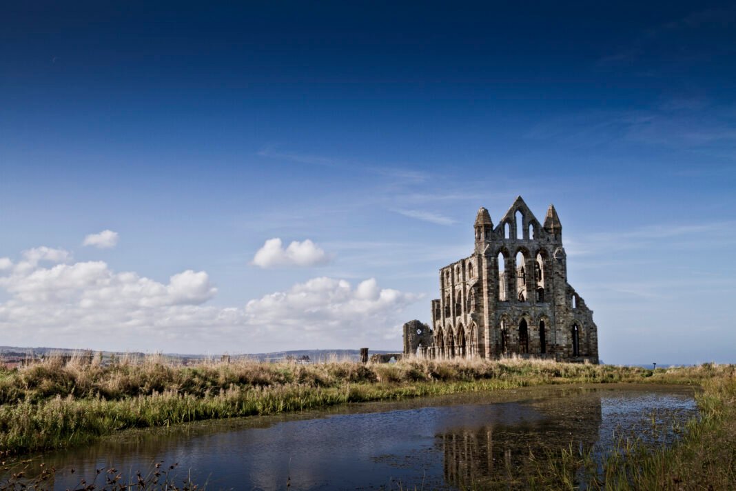 Underrated England: 9 Places Worth Visiting Beyond the Tourist Trail Ruined Gothic Whitby Abbey on the clifftop above the fishing port of Whitby, North Yorkshire, England