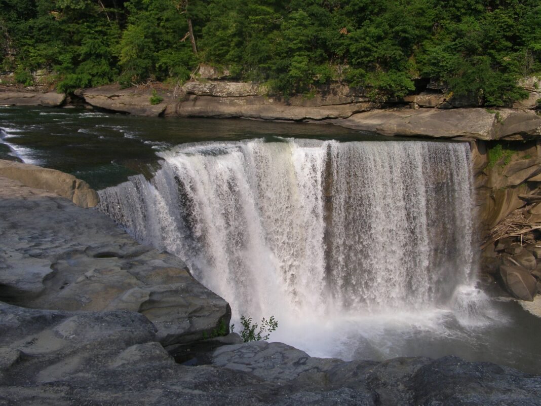 Kentucky Outdoor Activities 2026: Caves, Gorges, and Bluegrass Trails Cumberland Falls waterfall Kentucky wide curtain of water over a sandstone ledge in Daniel Boone National Forest