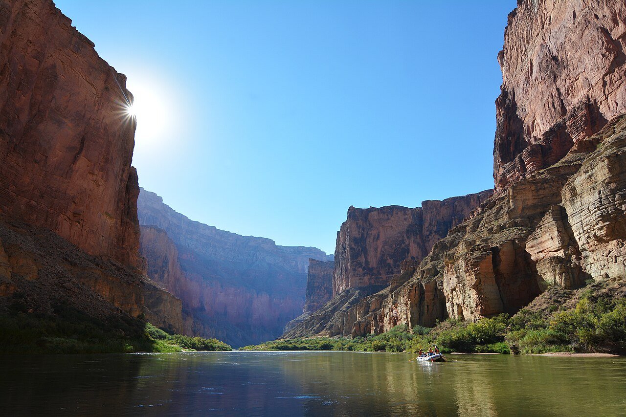 Rafting the Colorado River through the Grand Canyon with towering canyon walls rising on both sides Arizona