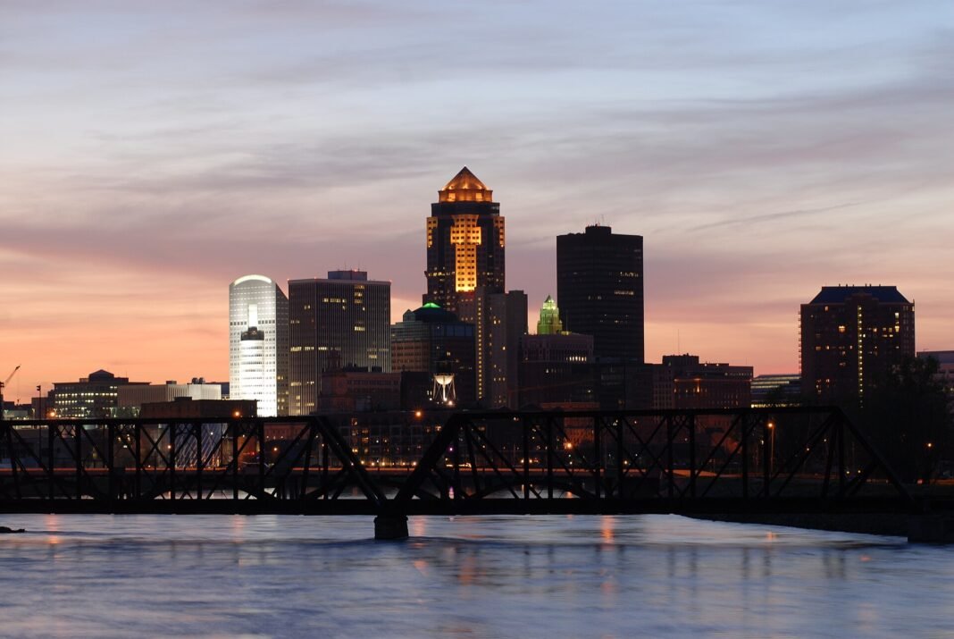 Iowa Travel Guide 2026: The Surprising Depth of America’s Heartland Downtown Des Moines skyline at dusk over the Des Moines River, Iowa