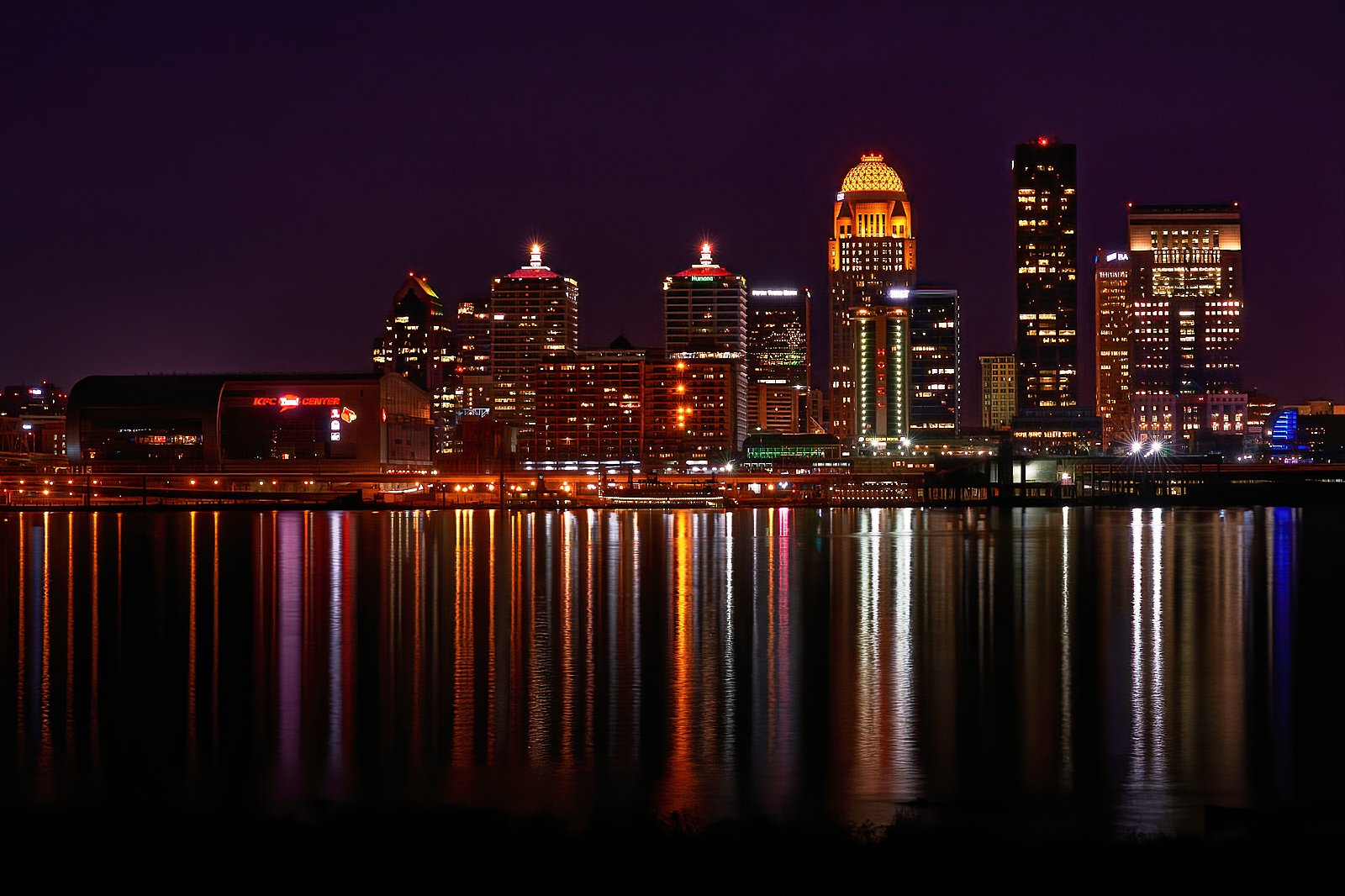Downtown Louisville Kentucky skyline at night reflected in the Ohio River