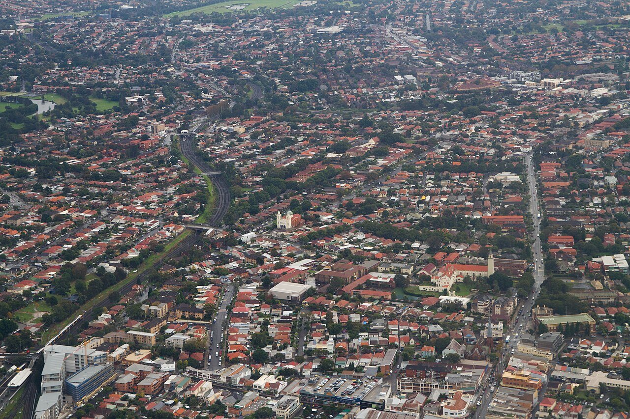 Aerial view of Sydney inner west residential suburb Marrickville red-roofed terraced houses tree-lined streets New South Wales
