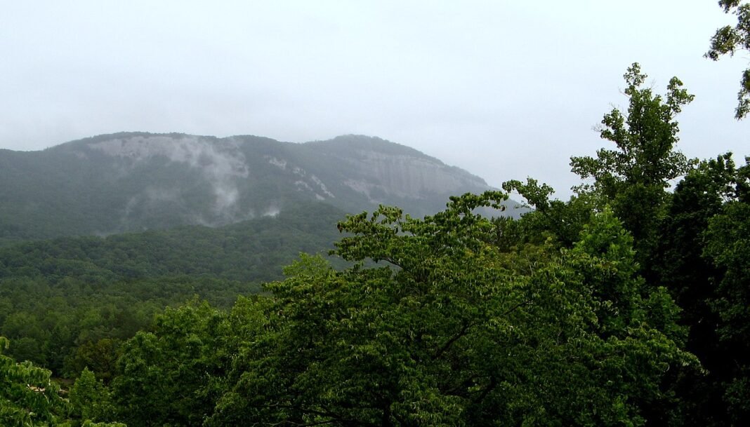 Outdoor Activities in South Carolina 2026: Waterfalls, Forests, and Coastline Table Rock Mountain 3124-foot granite dome rising above misty Pickens County forest in Table Rock State Park South Carolina Blue Ridge Escarpment Upstate