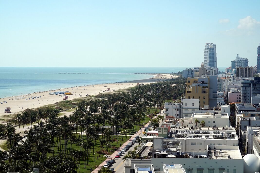 Miami Beach Travel Guide: Art Deco, Beaches, and Nightlife Aerial view of Miami Beach hotel skyscrapers, white-sand coastline, and Ocean Drive, Florida USA