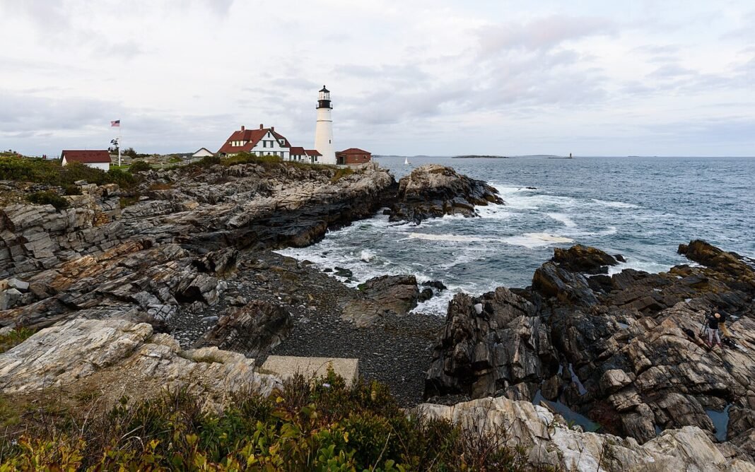 Best Places to Live in Maine 2026: City-by-City Guide Portland Head Light lighthouse on rocky coastline at Cape Elizabeth Maine Atlantic Ocean
