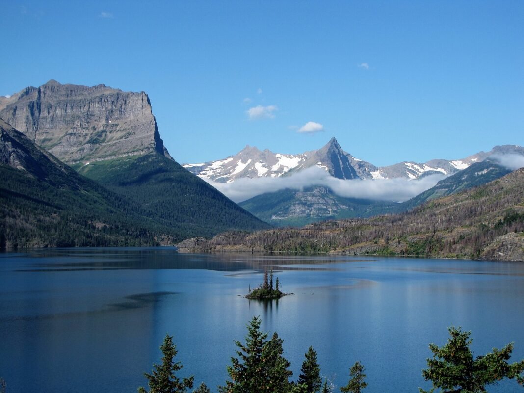 Outdoor Activities in Montana 2026: Big Sky, Big Rivers, Big Wilderness Wild Goose Island on Saint Mary Lake in Glacier National Park Montana with snow-streaked peaks and deep blue water